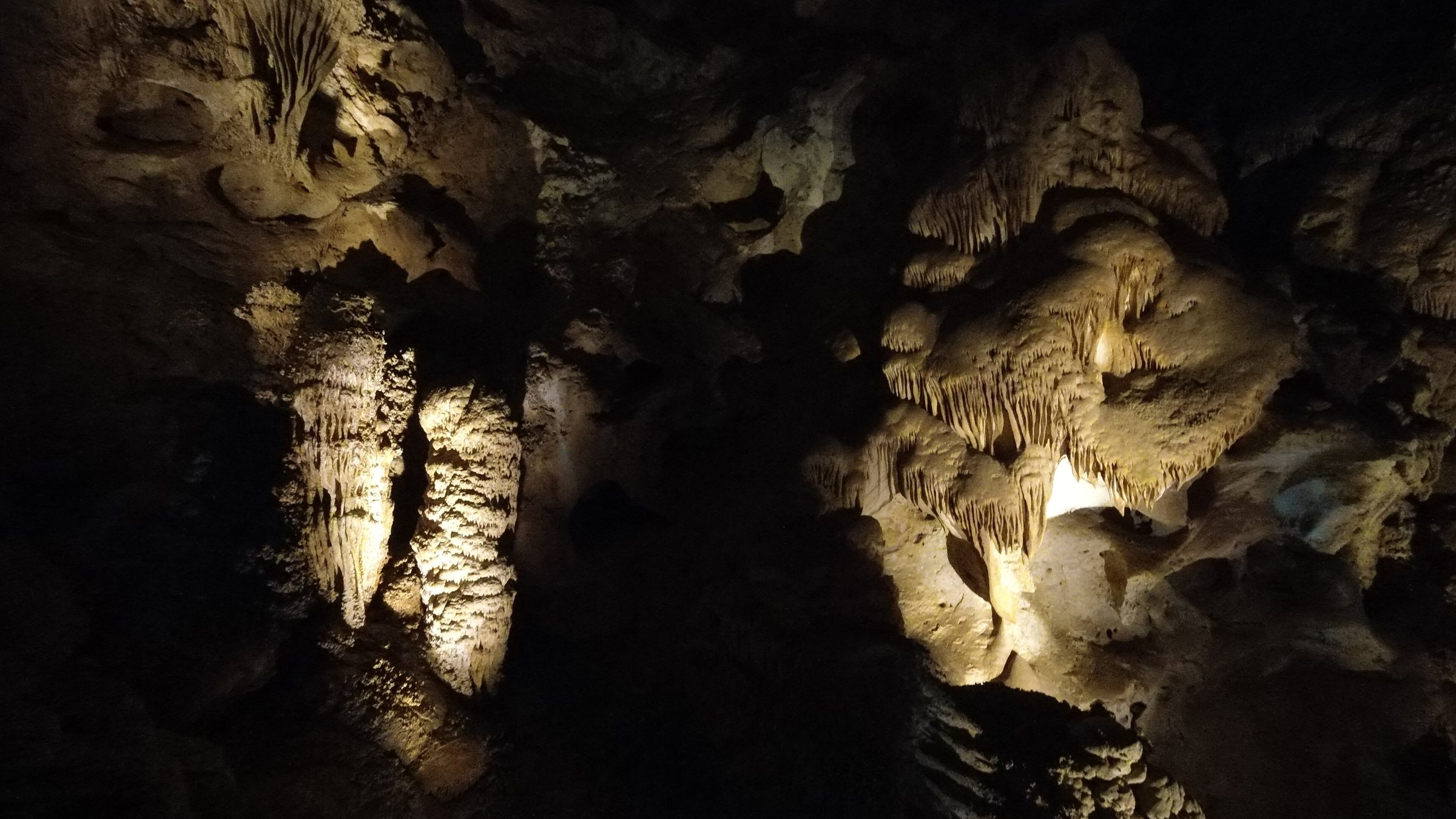 Illuminated stalactites and rock formations inside Carlsbad Caverns.