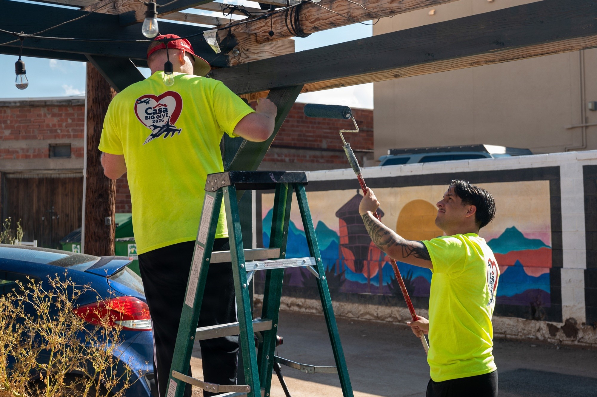 Two volunteers paint and improve a downtown public space in Alamogordo.