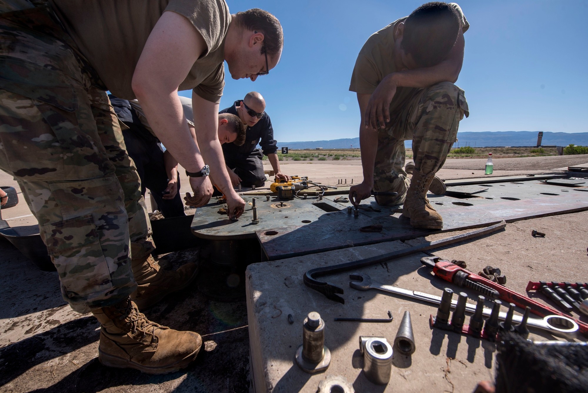 Electrical power production personnel work on equipment at Holloman Air Force Base in Otero County.
