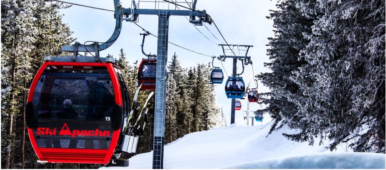 Gondolas at a snowy mountain ski area.