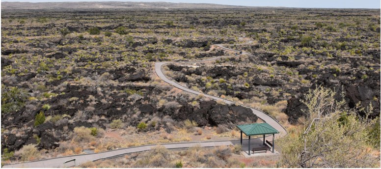 A walking path winding through a volcanic landscape.
