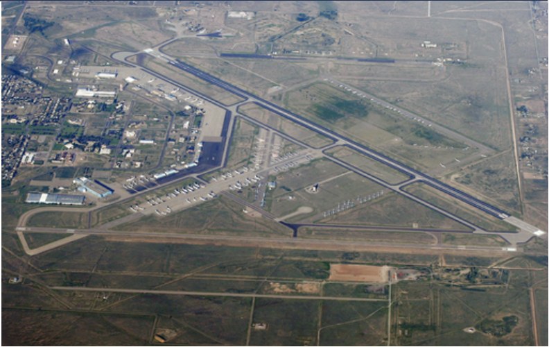 Aerial view of an airport and surrounding facilities.